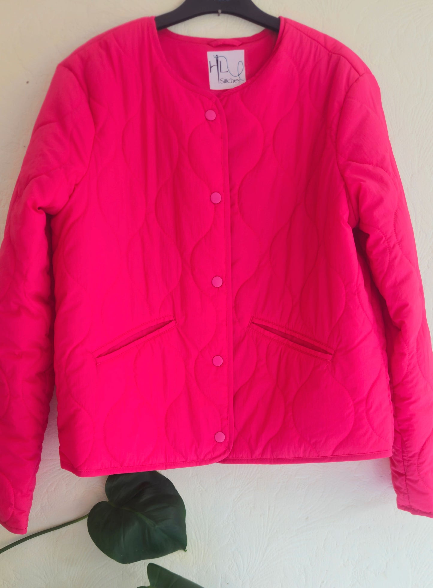 Vibrant pink quilted shower proof jacket with floral embroidery