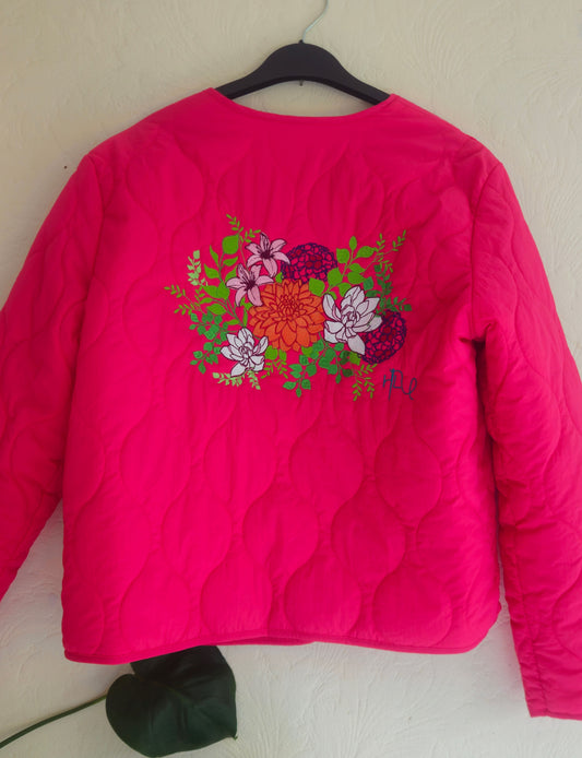 Vibrant pink quilted shower proof jacket with floral embroidery