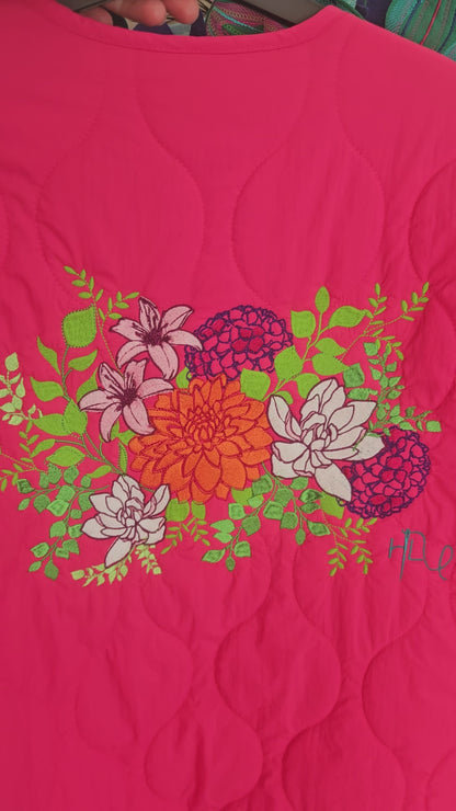 Vibrant pink quilted shower proof jacket with floral embroidery
